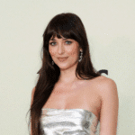 dakota johnson valentino campaign, valentino cruise 2026 fashion, dakota johnson red cutout minidress, alessandro michele valentino, dakota johnson off-the-shoulder dress, dakota johnson gucci ambassador, dakota johnson balenciaga outfit, dakota johnson street style 2025, dakota johnson luxury accessories, dakota johnson emerald necklace, dakota johnson diamond collar, dakota johnson gucci sunglasses, kate young dakota johnson stylist, dakota johnson fashion campaigns, dakota johnson floral tights,