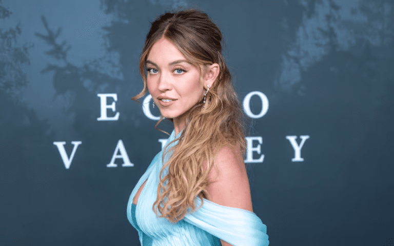 Sydney Sweeney glittering crystal Miu Miu gown, Sydney Sweeney feather boa Old Hollywood look, Sydney Sweeney The Housemaid New York screening, Sydney Sweeney bombshell red carpet style, Sydney Sweeney custom Miu Miu fashion partnership, Sydney Sweeney Amanda Seyfried Gotham red carpet, Sydney Sweeney bouffant hairstyle Glen Oropeza, Sydney Sweeney makeup Melissa Hernandez beauty look, Sydney Sweeney daring fashion evolution 2025, Sydney Sweeney red carpet glamour moments