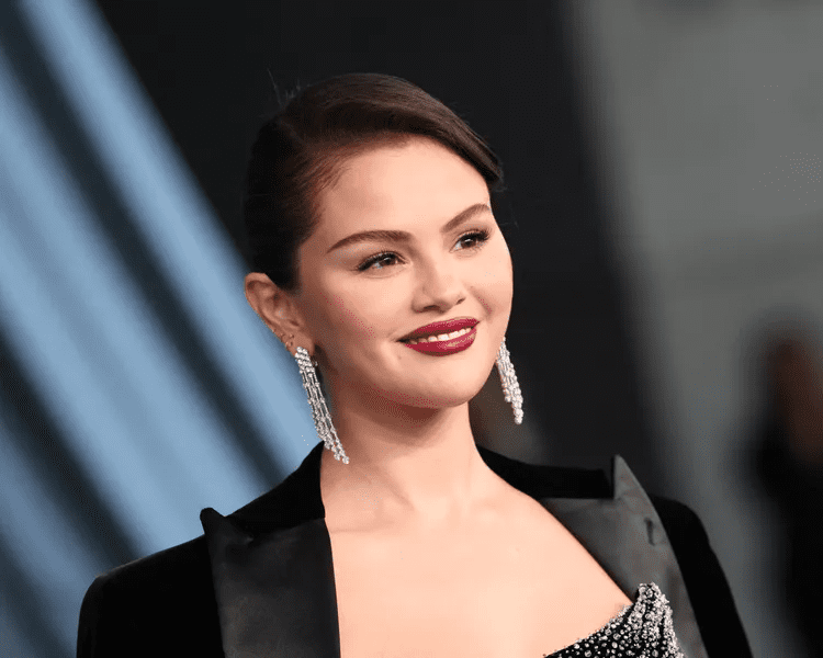 Selena Gomez holiday outfit, Selena Gomez lace trimmed LBD, Selena Gomez Santa hat look, Selena Gomez Christmas décor 2025, Selena Gomez Benny Blanco holiday season, Selena Gomez festive Instagram photos, Selena Gomez semi sheer tights outfit, Selena Gomez Mindy Weiss decorations, Selena Gomez newlywed Christmas, Selena Gomez holiday fashion inspiration