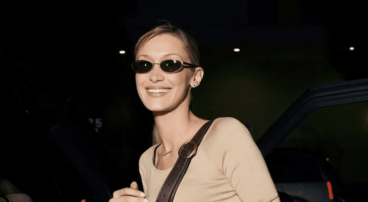 Bella Hadid bra strap trend, Bella Hadid bootcut jeans look, Bella Hadid nude Valentino top, Bella Hadid Coach Tabby bag, Bella Hadid daring fashion 2026, Bella Hadid visible bra straps, Bella Hadid street style Los Angeles, Bella Hadid Ryan Murphy The Beauty series, Bella Hadid acting career, Bella Hadid viral outfit